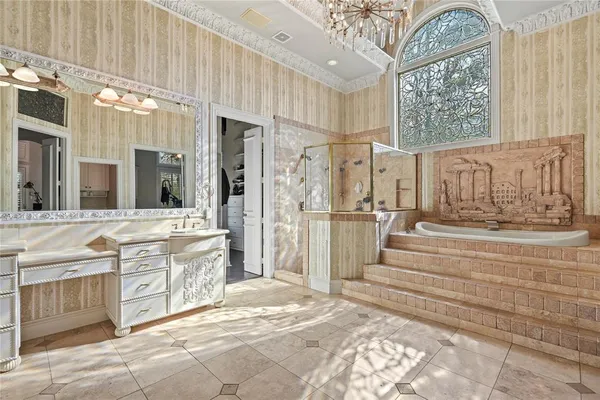 a spacious bathroom with a tub sink and mirror