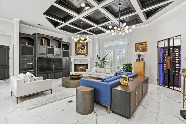 a living room with fireplace furniture and a chandelier