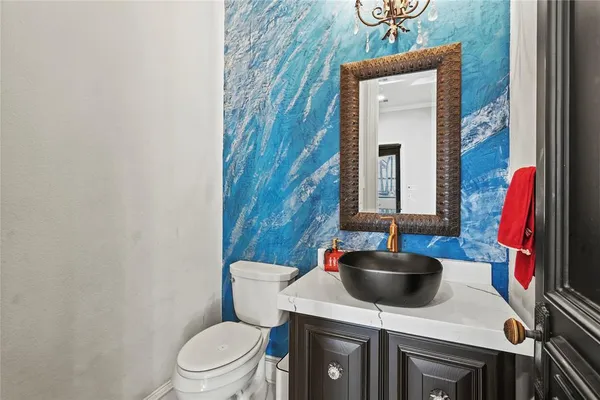 a bathroom with a toilet a sink and a mirror