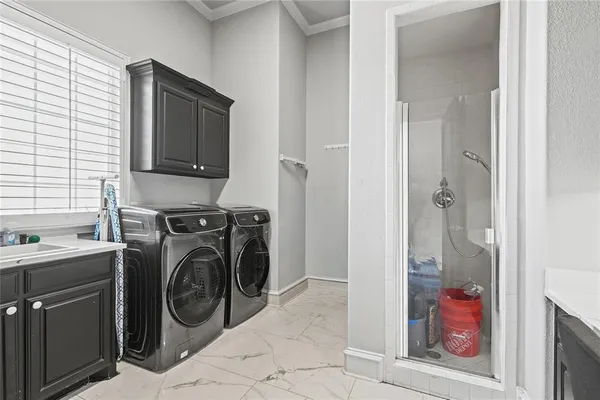 a utility room with closet dryer and washer