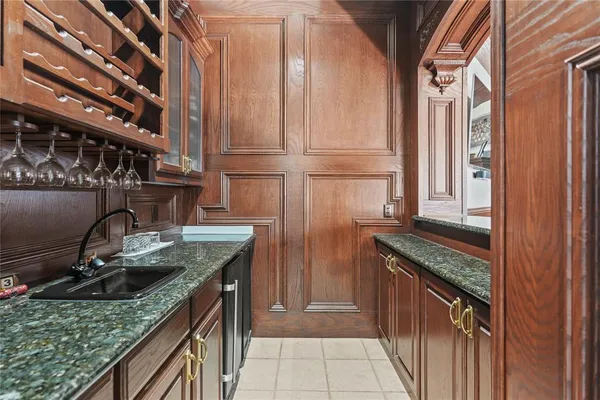 a kitchen with granite countertop a sink and a stove