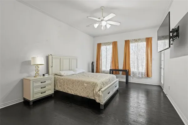 a spacious bedroom with a bed and a chandelier