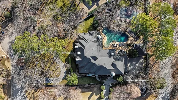 an aerial view of a house with a yard and garden