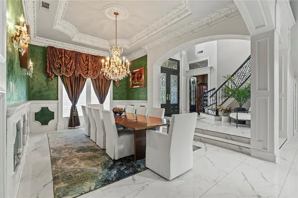 a view of a dining room with furniture wooden floor and a chandelier