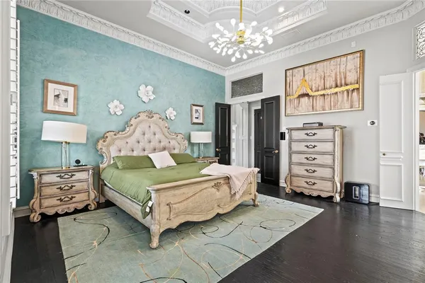 a bedroom with a bed and a chandelier