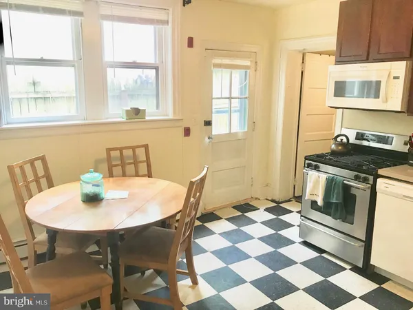 a kitchen with a table and a stove top oven
