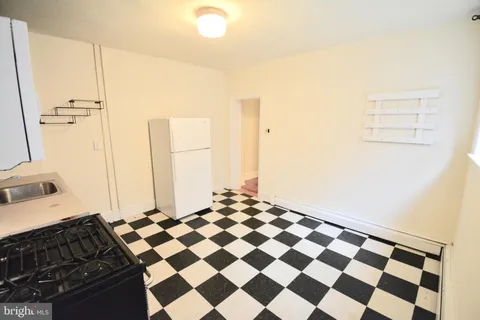 a bedroom with a black and white checkered floor