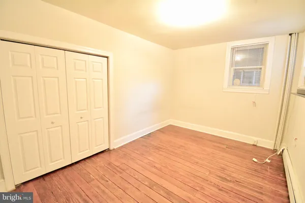 an empty room with wooden floor
