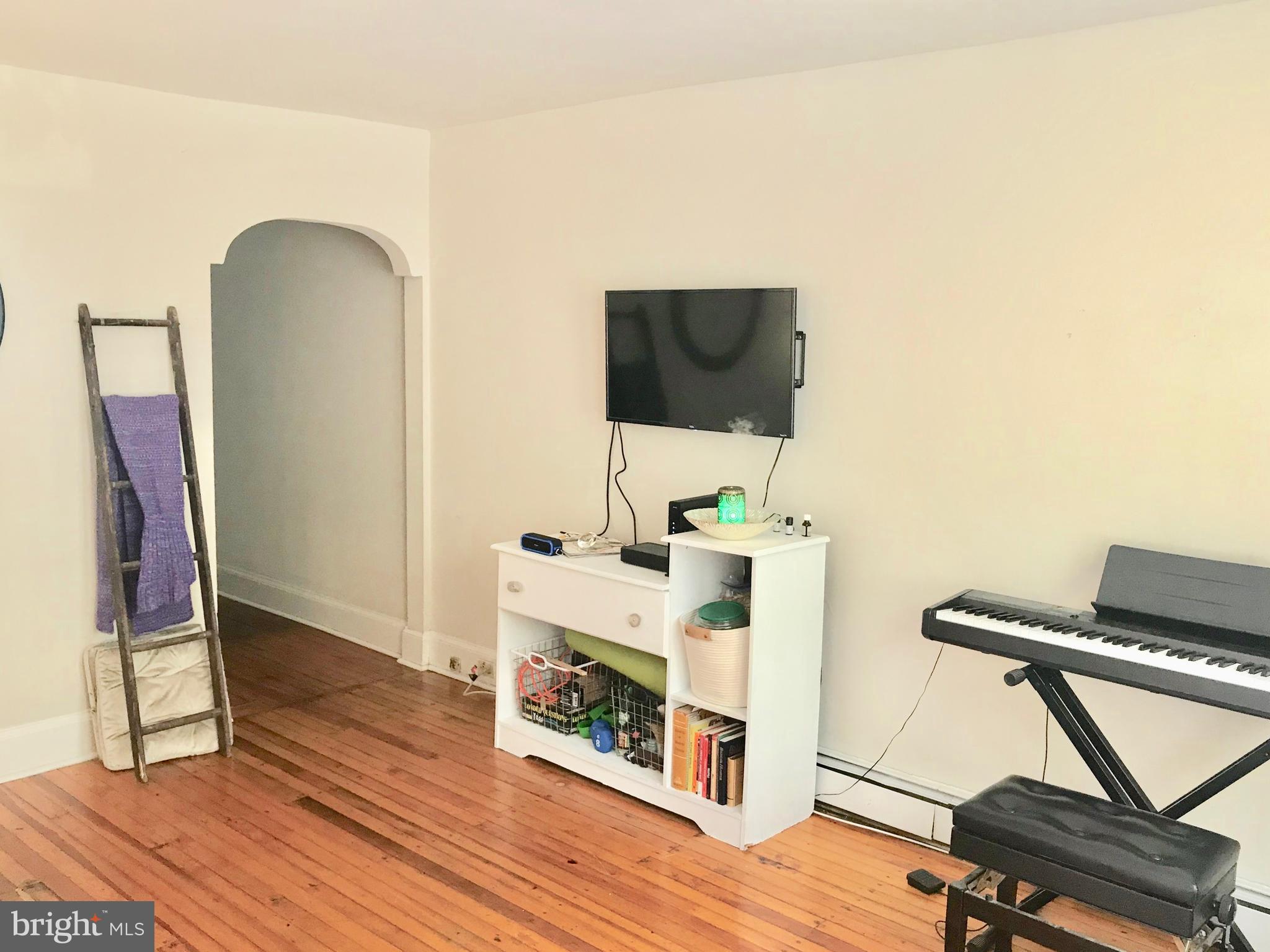 3694 Calumet Street, Unit 1 Philadelphia, PA 19129 - Photo 2 of 18 a living room with furniture and a flat screen tv