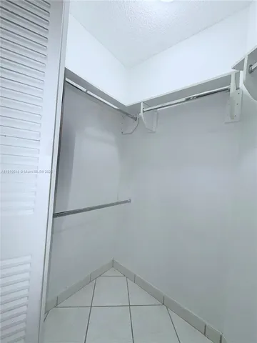 a living room with furniture a flat screen tv and a table