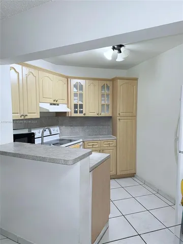 a kitchen with stainless steel appliances granite countertop a sink and cabinets