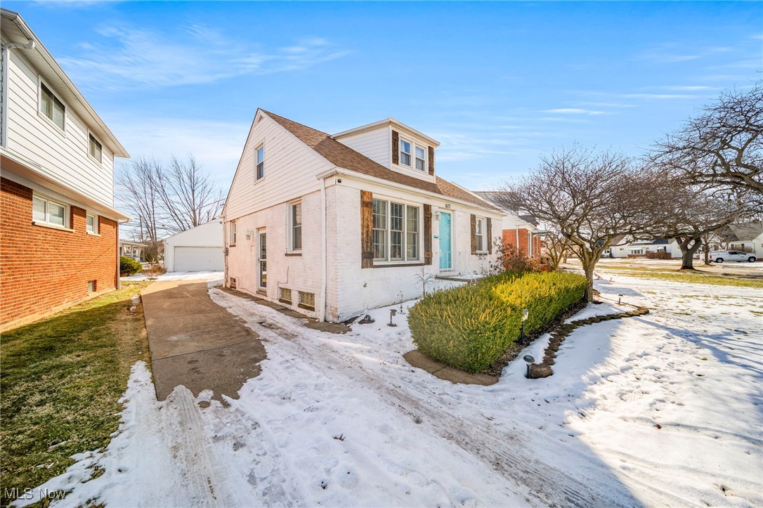 617 Pendley Road Willowick, OH 44095 - Photo 2 of 44 View of snow covered exterior featuring an outbuilding and a garage