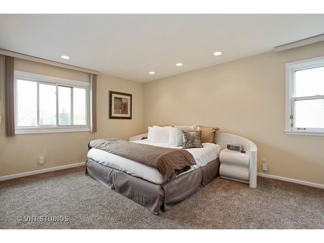 2109 Valley Road Northbrook, IL 60062 - Photo 7 of 13 a spacious bedroom with a bed and a window