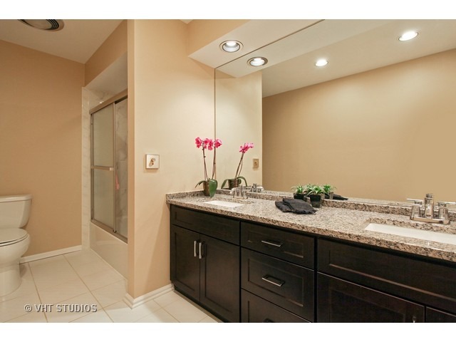 2109 Valley Road Northbrook, IL 60062 - Photo 9 of 13 a bathroom with a granite countertop sink and a mirror