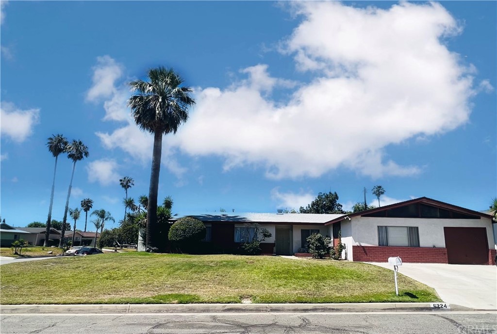 a view of a house with a swimming pool and a yard
