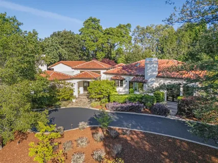an aerial view of a house with yard and outdoor seating