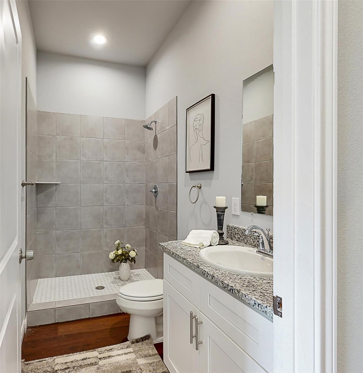 18813 Luminescent Lane Spring, TX 77379 - Photo 14 of 19 a bathroom with a granite countertop sink toilet a mirror and shower