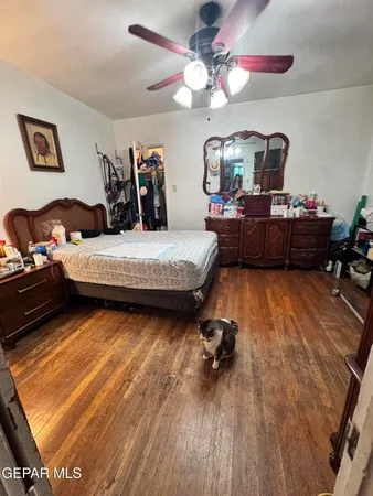 a bed room with furniture and mirror