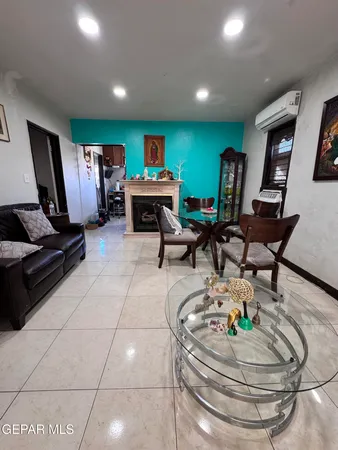 a living room with patio furniture and a flat screen tv