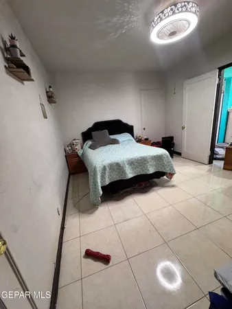 a bedroom with a bed and a mirror