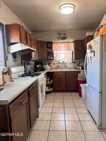 a kitchen with a sink a stove and a refrigerator