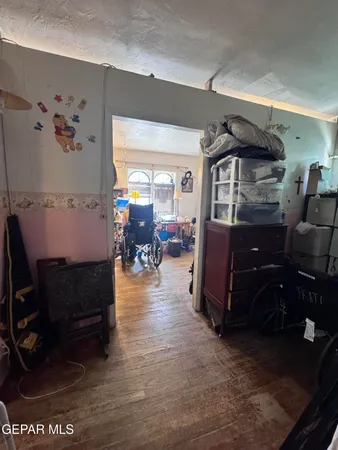 a bedroom with furniture and a wooden floor