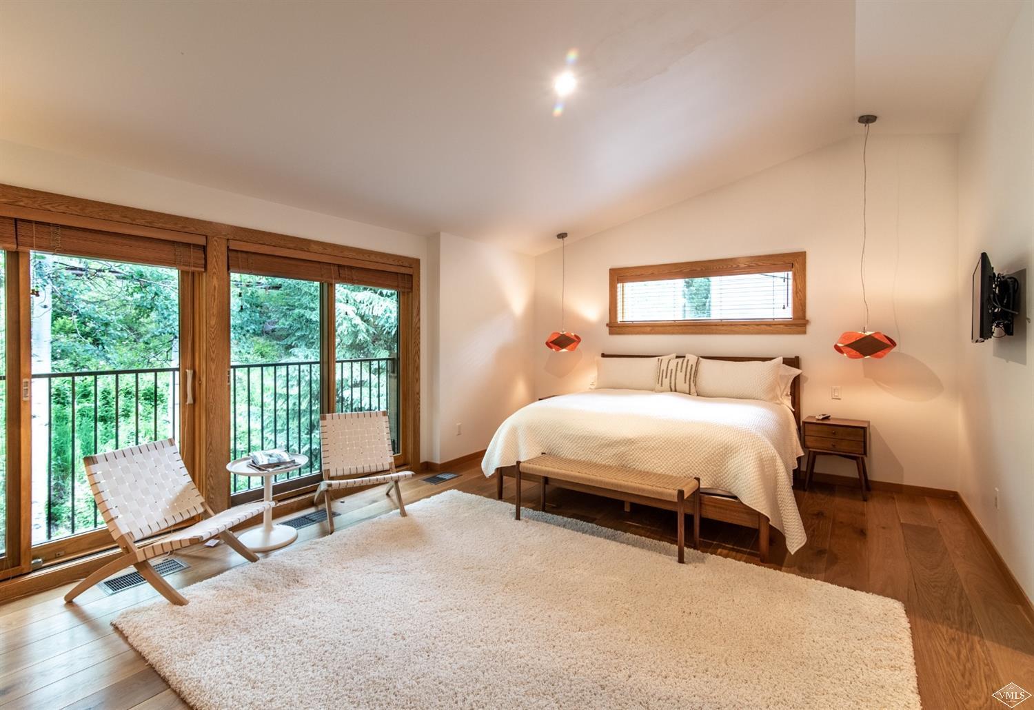 950 Red Sandstone Road, Unit 40 Vail, CO 81657 - Photo 13 of 23 a bedroom with a bed and large window