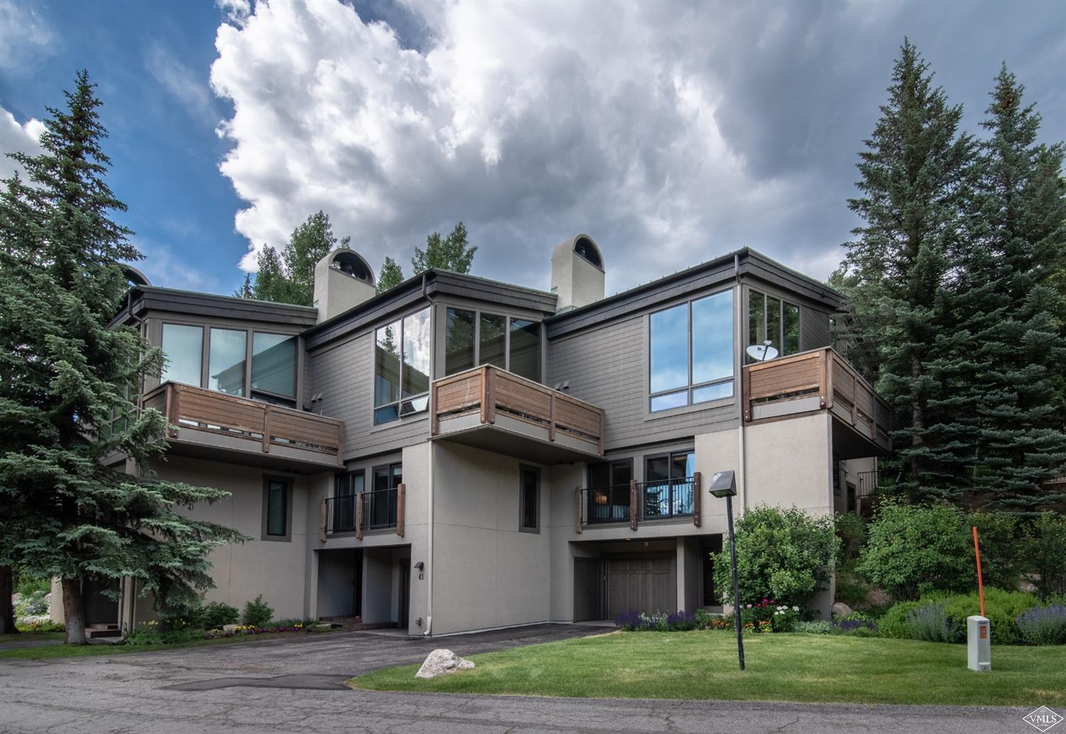 950 Red Sandstone Road, Unit 40 Vail, CO 81657 - Photo 2 of 23 a front view of a house with a garden