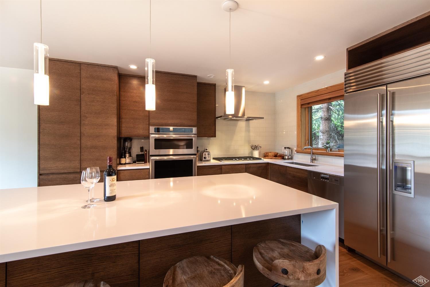 950 Red Sandstone Road, Unit 40 Vail, CO 81657 - Photo 7 of 23 a kitchen with kitchen island a sink appliances and cabinets