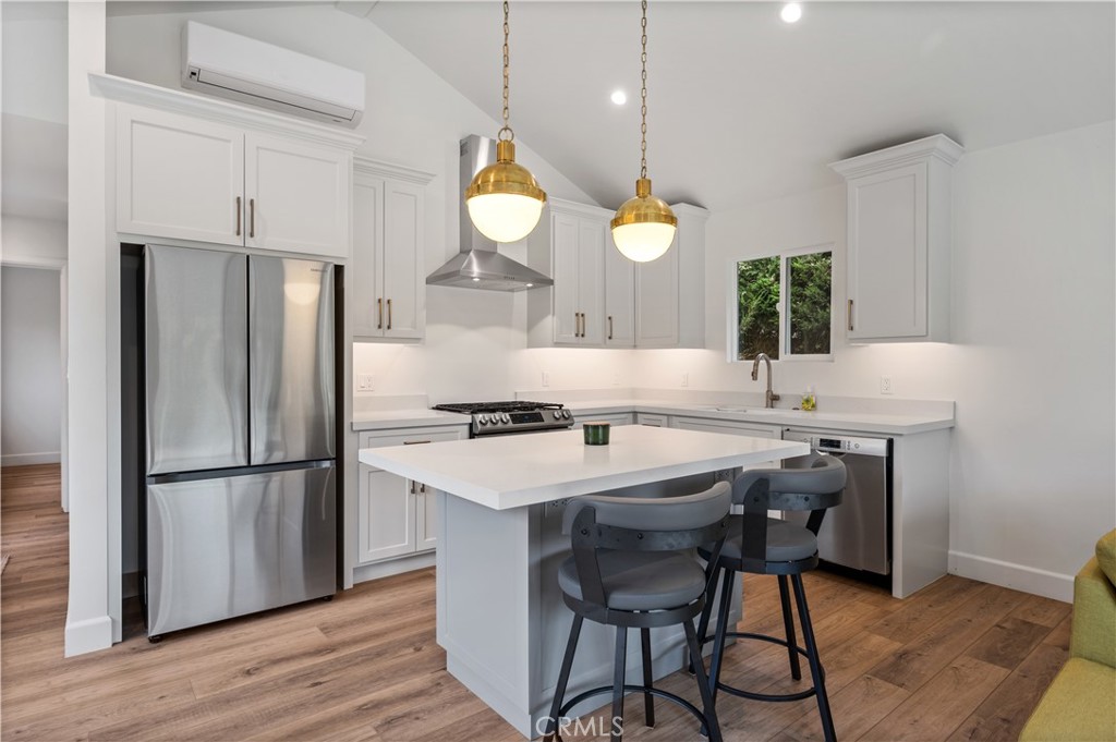 60 Ranchview Road, Unit 1/2 Rolling Hills Estates, CA 90274 - Photo 5 of 21 a kitchen with a table chairs refrigerator and microwave