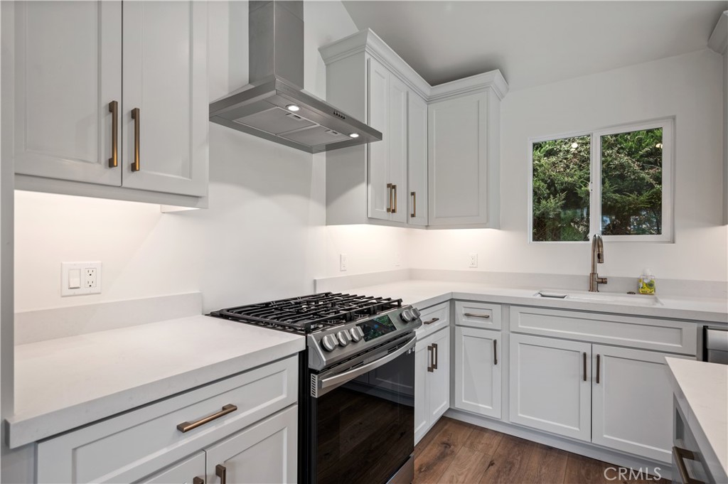 60 Ranchview Road, Unit 1/2 Rolling Hills Estates, CA 90274 - Photo 6 of 21 a kitchen with white cabinets and appliances
