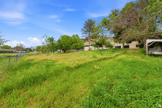 871 Bonita Way Centerville, UT 84014 - Photo 51 of 61 Grassy terrain with a gentle slope and partial chain-link fencing