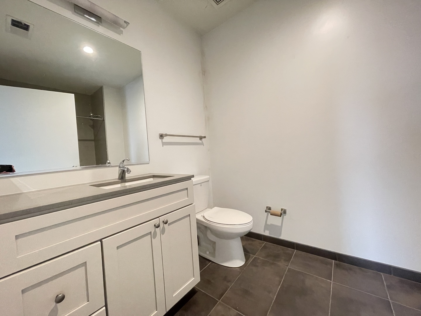 Undisclosed Address Chicago, IL 60642 - Photo 14 of 25 a bathroom with a toilet a sink and mirror