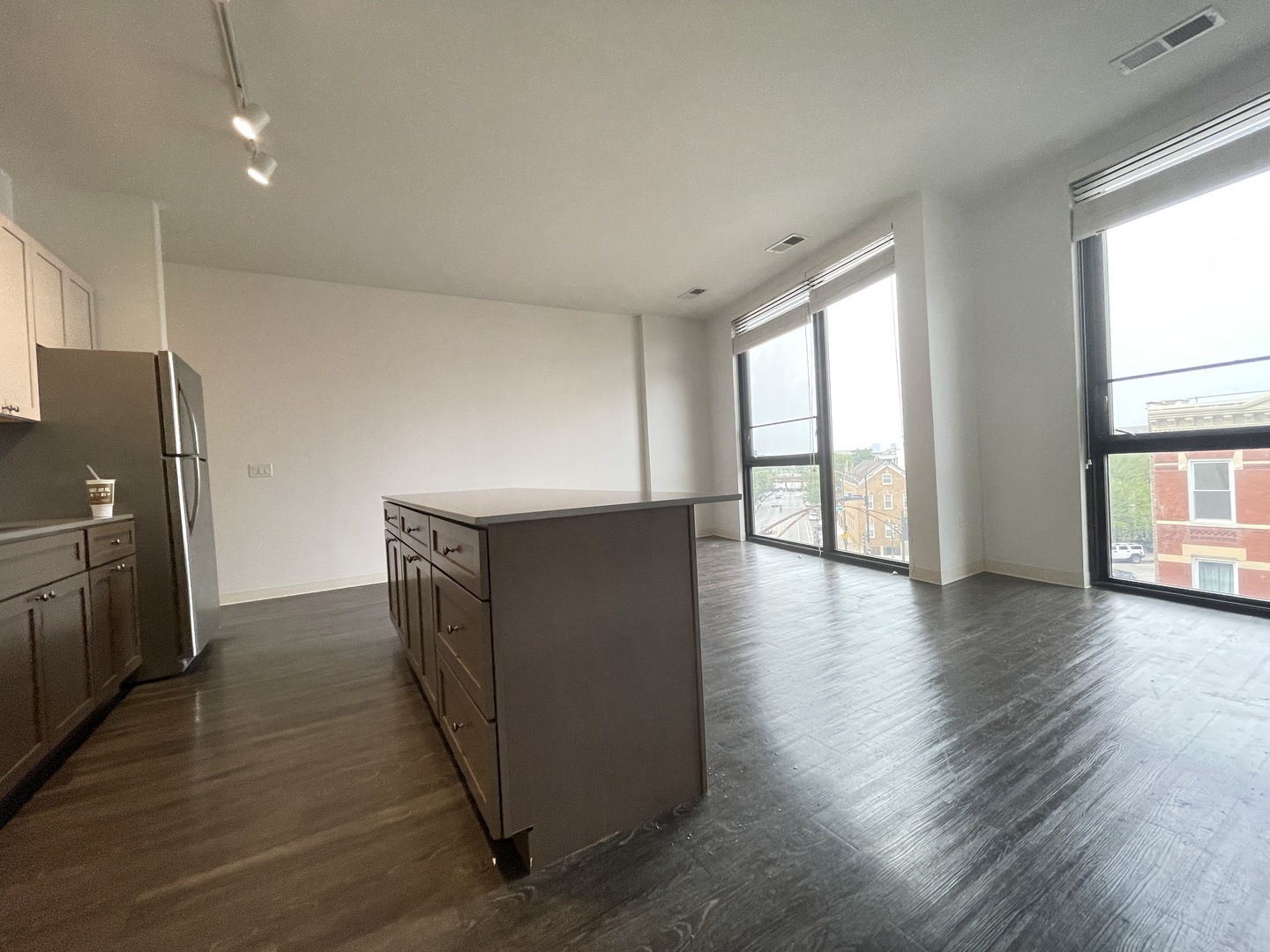 Undisclosed Address Chicago, IL 60642 - Photo 15 of 25 an empty room with wooden floor and windows