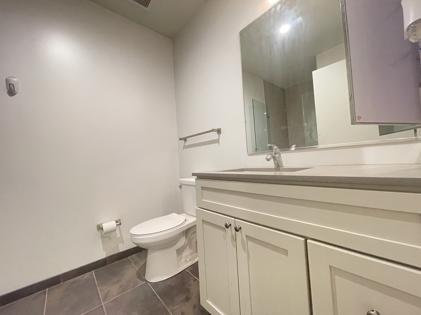 Undisclosed Address Chicago, IL 60642 - Photo 18 of 25 a bathroom with a toilet a sink and mirror