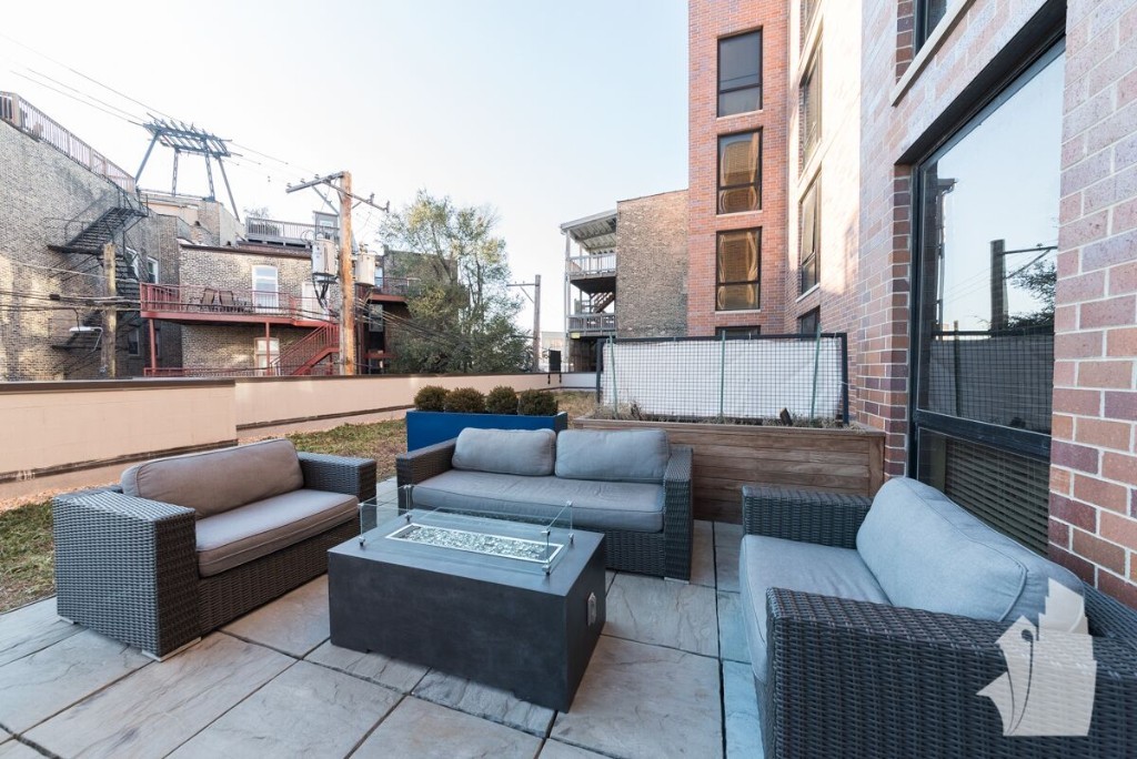 Undisclosed Address Chicago, IL 60642 - Photo 24 of 25 a outdoor space with patio the couches and a fireplace