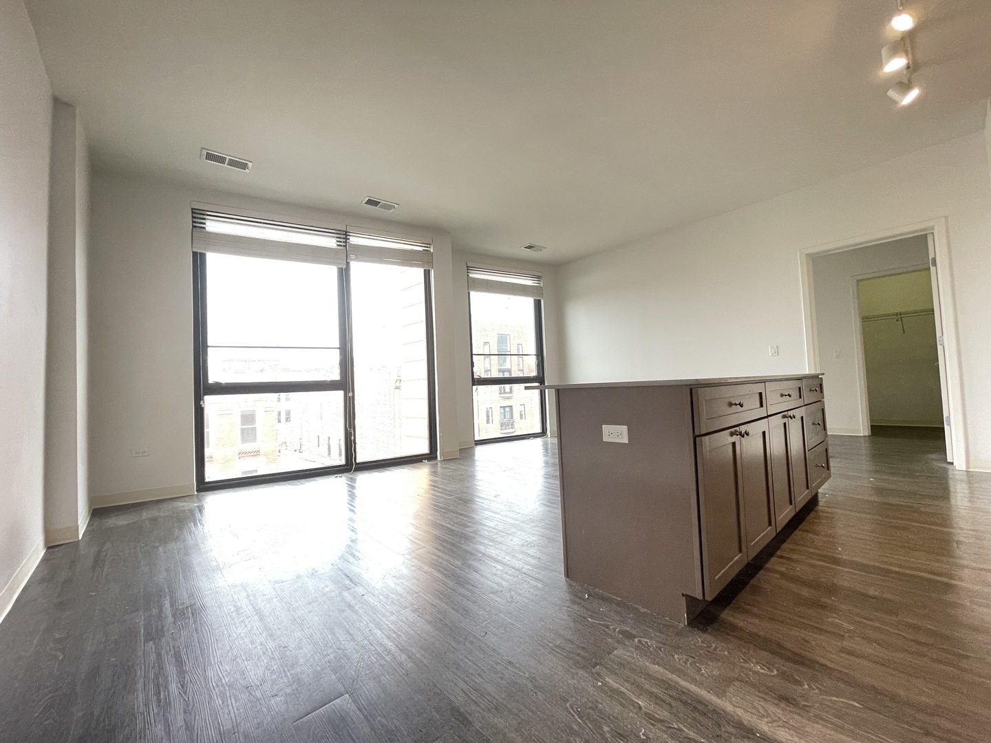 Undisclosed Address Chicago, IL 60642 - Photo 5 of 25 a view of an empty room with wooden floor and a window