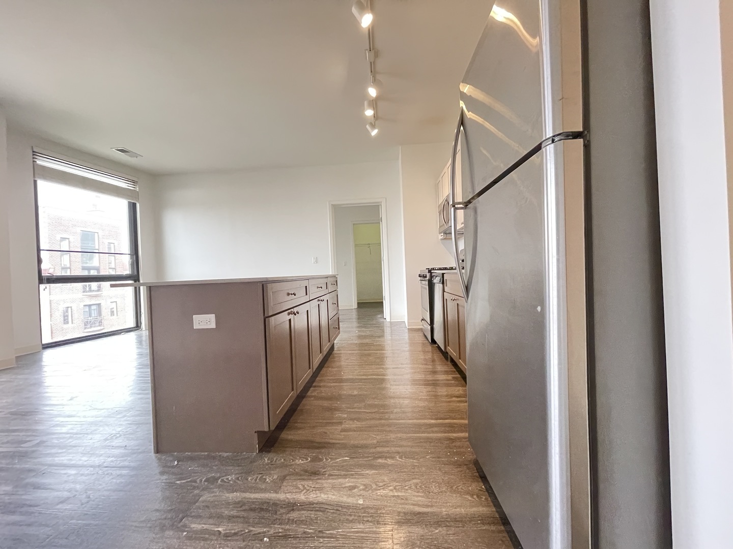 Undisclosed Address Chicago, IL 60642 - Photo 6 of 25 a view of hallway with wooden floor and stairs