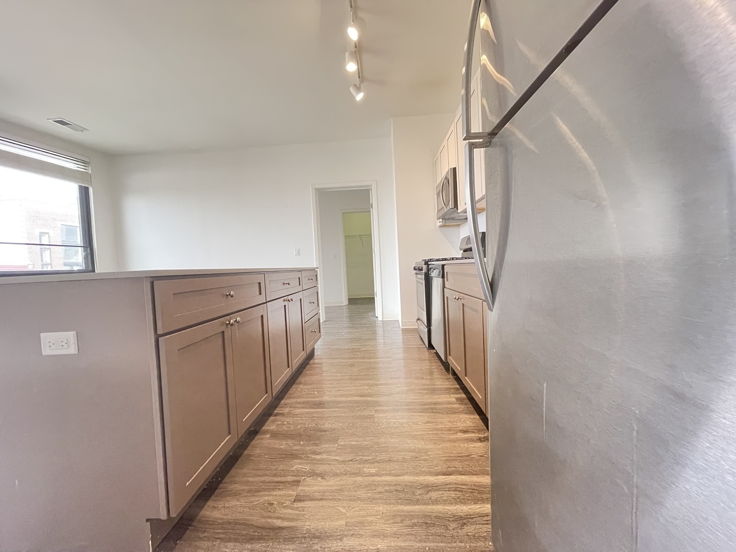 Undisclosed Address Chicago, IL 60642 - Photo 7 of 25 a view of a hallway with wooden floor and staircase