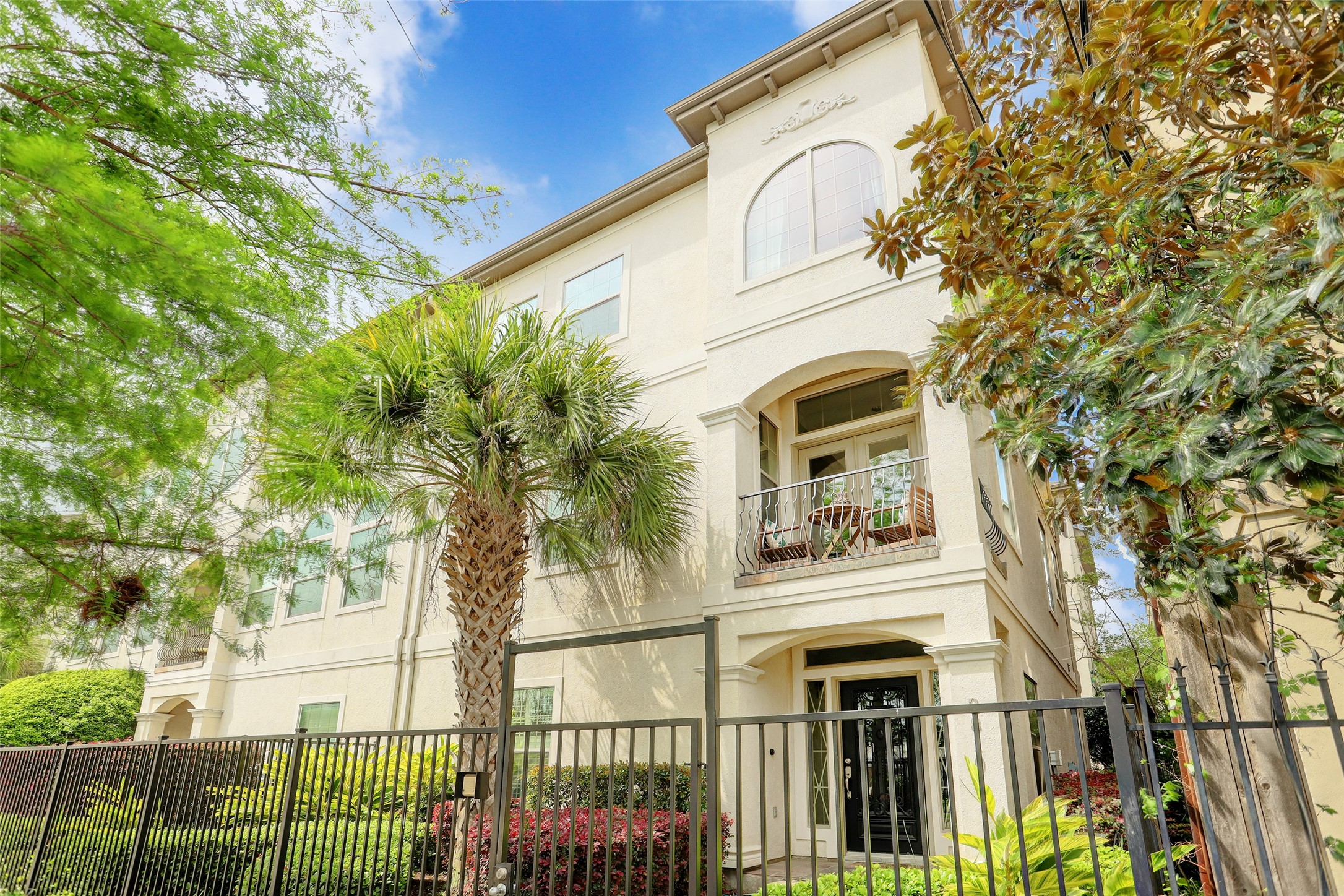 a view of a multi story residential apartment building with a tree