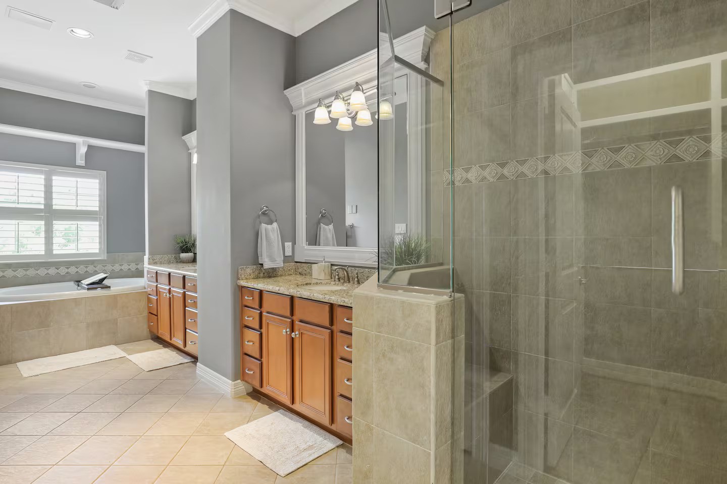 2810 Helena Street Houston, TX 77006 - Photo 13 of 16 a bathroom with a granite countertop sink a large mirror and a bathtub