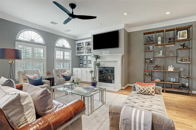 a living room with fireplace furniture and a flat screen tv
