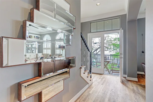 a living room with furniture a flat screen tv and a floor to ceiling window