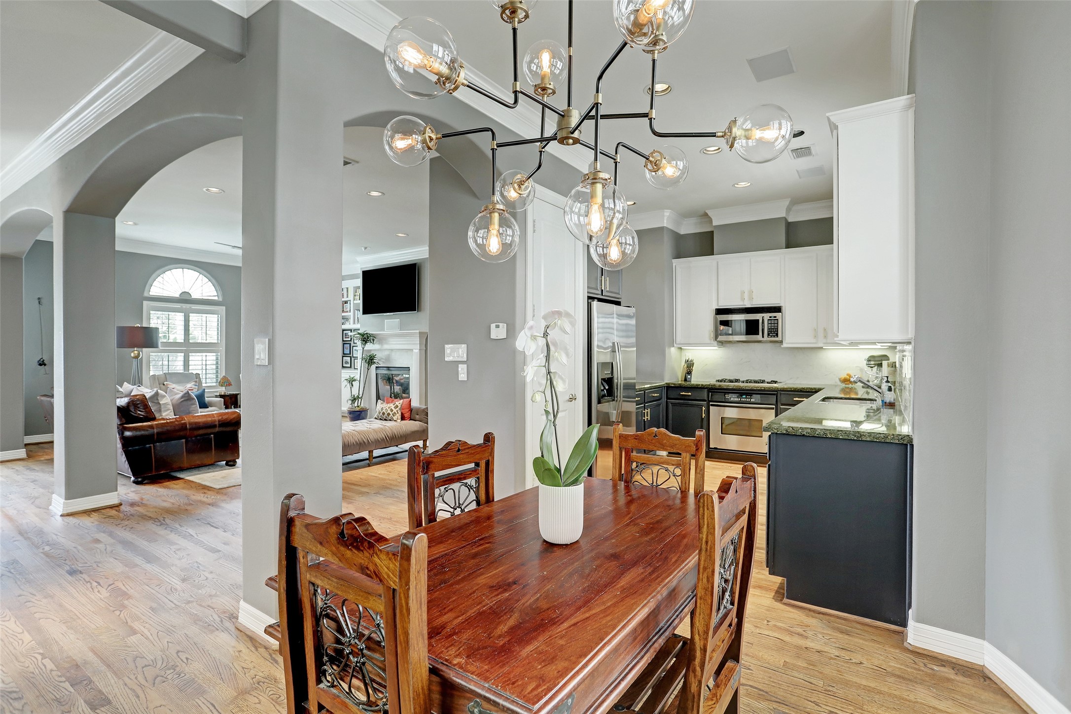 2810 Helena Street Houston, TX 77006 - Photo 8 of 16 a very nice looking dining room with kitchen island furniture a chandelier and a view of kitchen