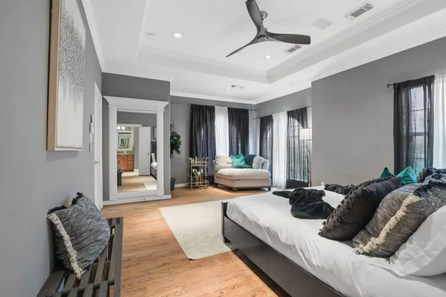 a bedroom with furniture and a large window