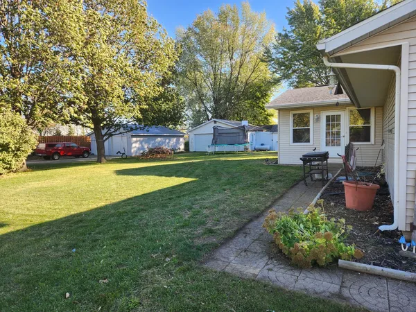 a view of a house with a yard patio and a patio