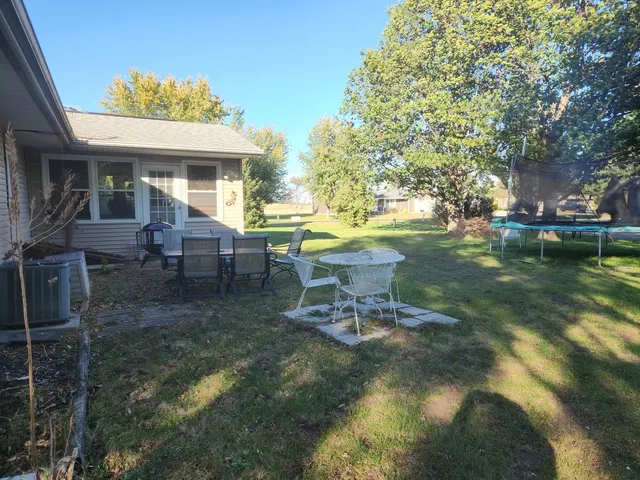 a view of a house with backyard porch and sitting area