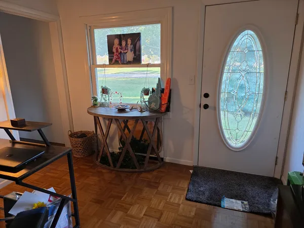 a view of a livingroom with furniture and a window