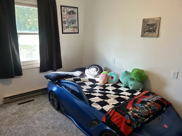 a bed sitting in a bedroom next to a window