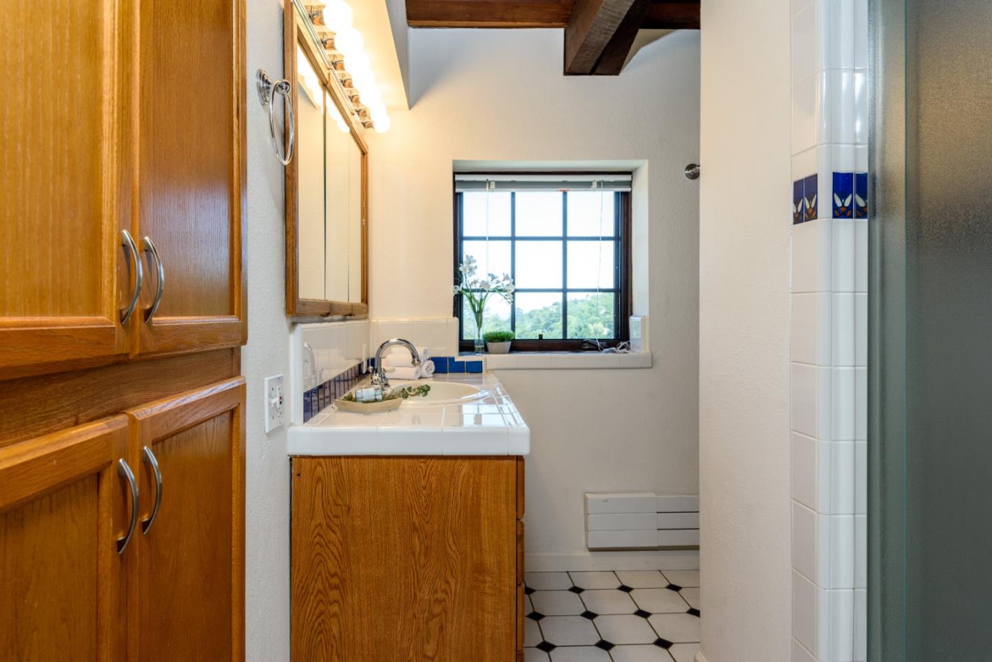 248 Exeter Avenue San Carlos, CA 94070 - Photo 16 of 28 a bathroom with a granite countertop sink and a mirror